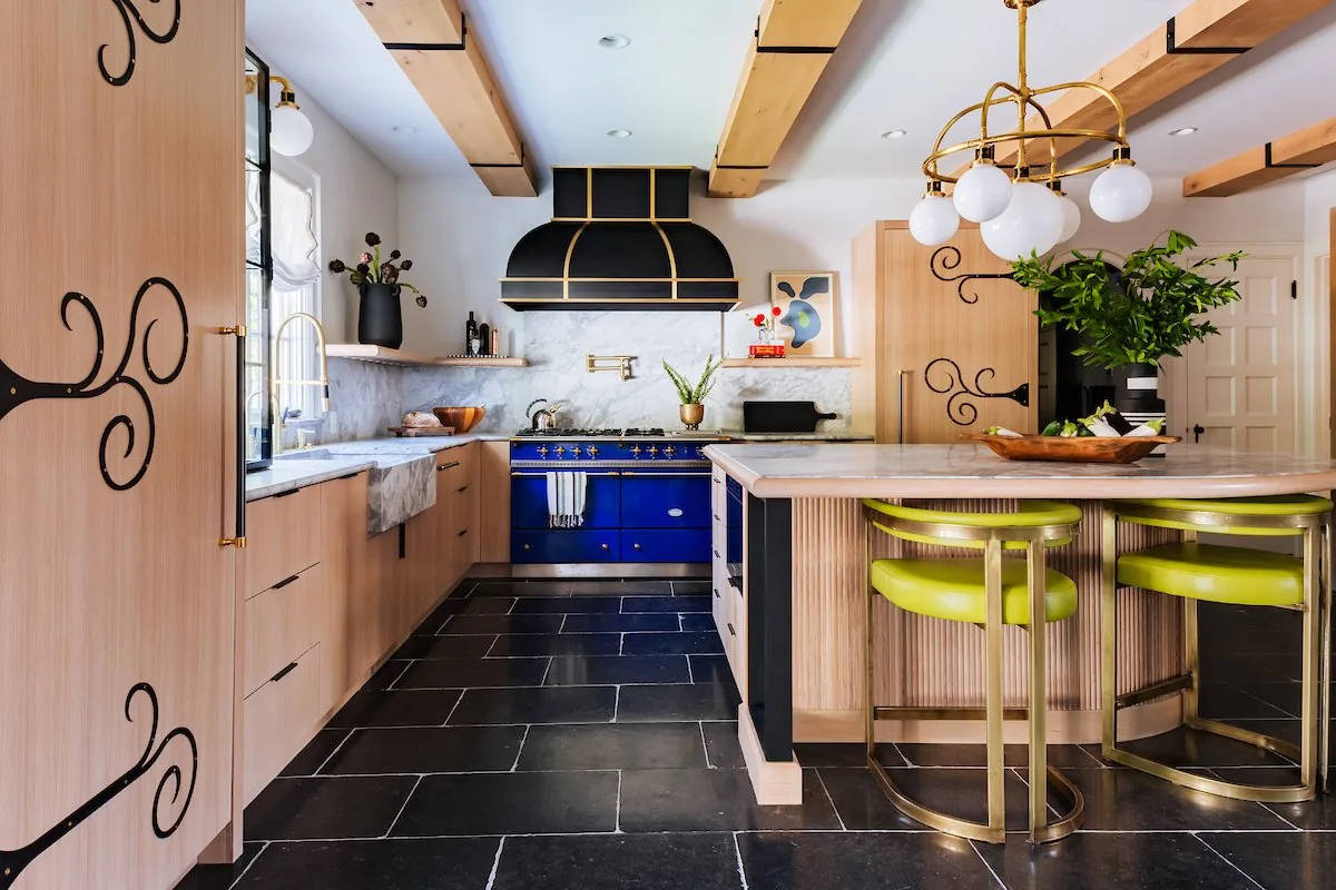 Happy Hollow kitchen, cobalt blue Lacanche range, custom oak cabinetry with iron scrollwork, marble backsplash, and chartreuse bar stools. Studio Eckström