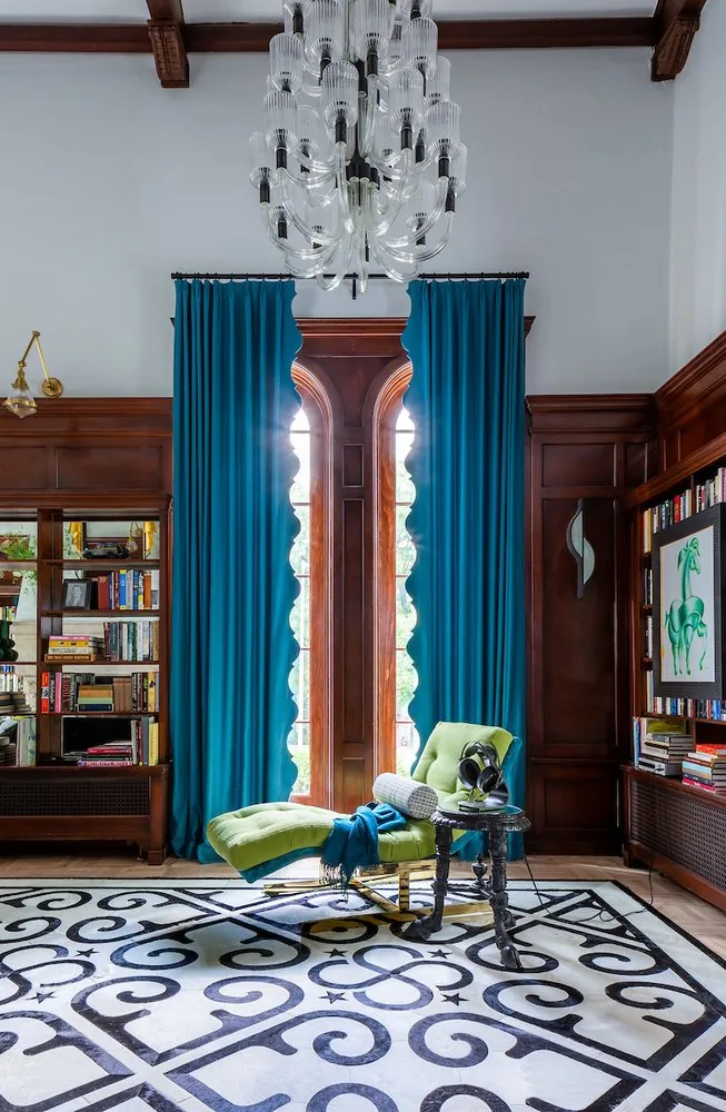 Happy Hollow salon, teal silk floor-to-ceiling curtains, arched Gothic window, and chartreuse chaise longue. Studio Eckström