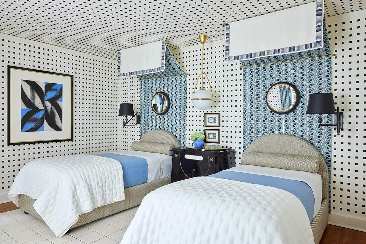 The Werkstaate Room, twin bedroom with grid dot wallpaper across walls and ceiling, upholstered beds, and patterned canopies. The Dundee Remodel, Studio Eckström Omaha