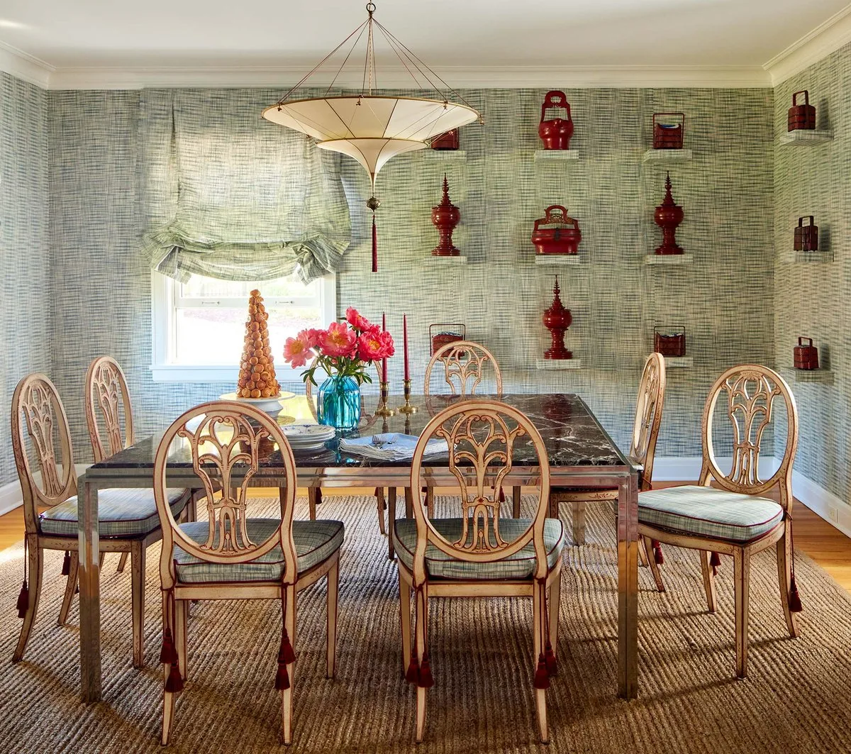 The Westchester dining room, grey-green grass cloth, floating shelves of antique Japanese red lacquerware, parasol pendant, and carved Hepplewhite chairs. Studio Eckström Omaha