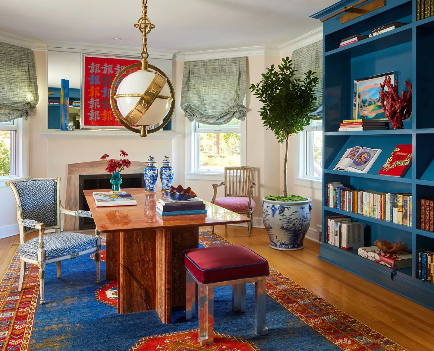 The Westchester Refresh library by Studio Eckström, floor-to-ceiling teal lacquered shelves, marble-top desk, and antique Persian rug, Omaha Nebraska