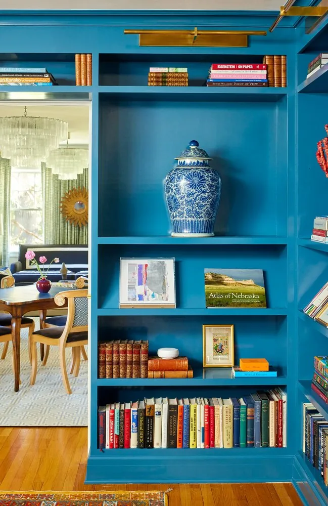 Interior design consulting and concept development by Studio Eckström, curated library shelving with art books and layered lighting